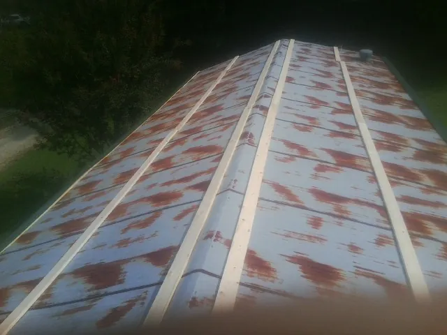 Rusted metal roof panels with new wood purlins before replacement — Storm Damage Roof Repair in Placerville by Roofing Brothers